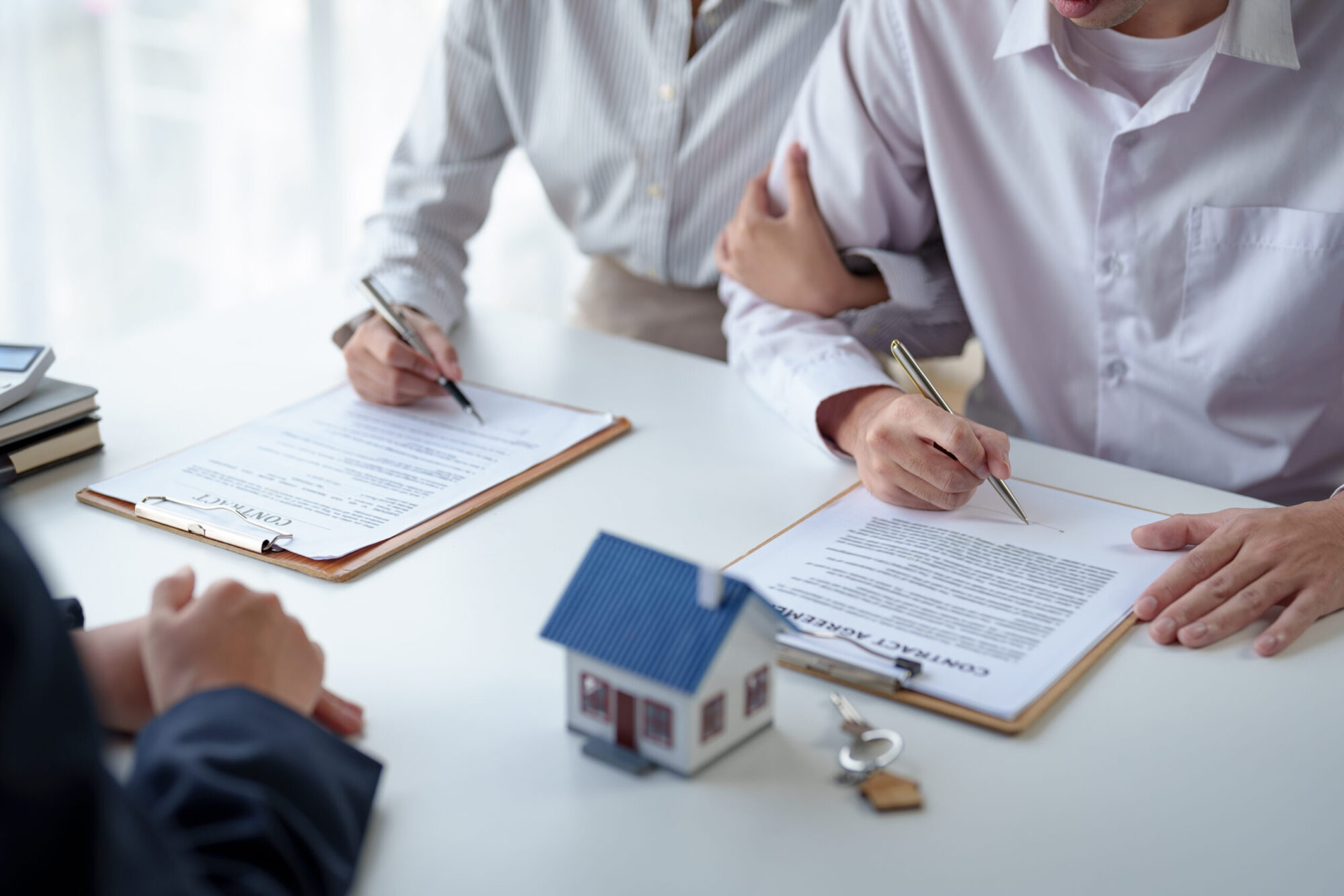 Couple entered into a house sale contract with a real estate agent. Hand over the house keys and calculate the installment and mortgage expenses and make insurance and sign contracts.